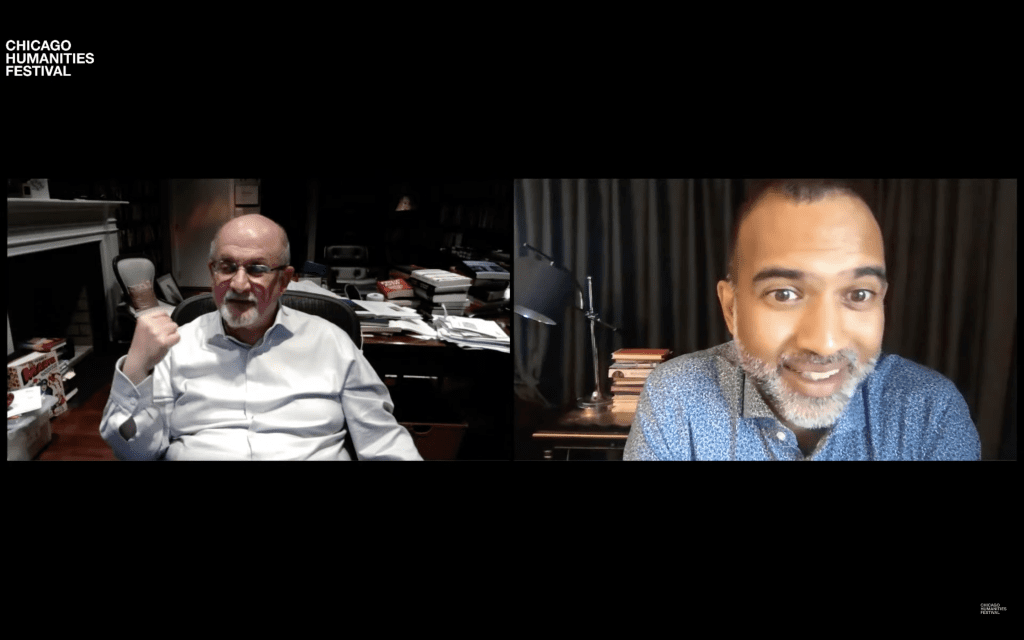 Salman Rushdie (l) gestures to his Marvel comics while speaking with Srikanth Reddy (r)