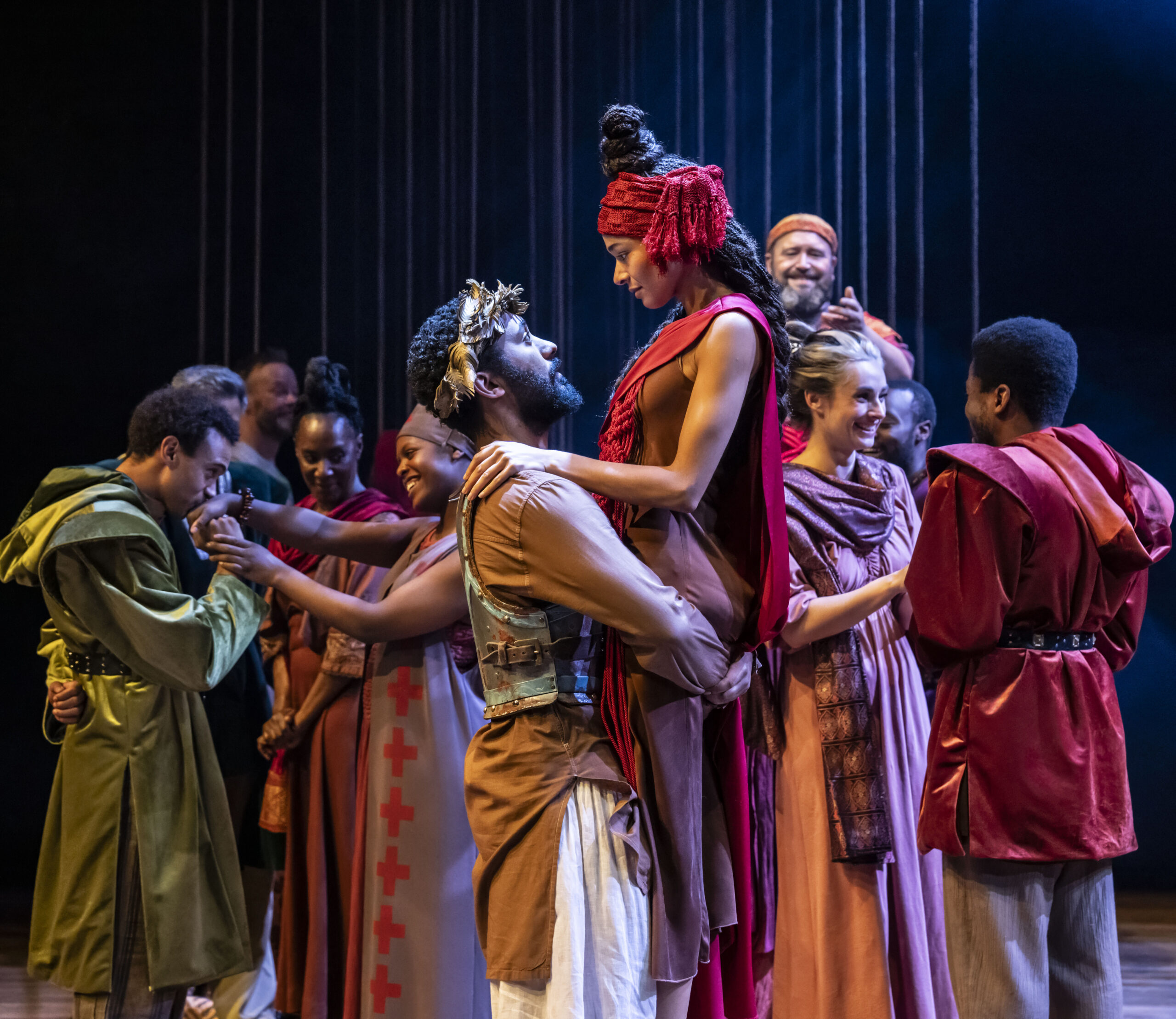 Zach Wyatt as Pericles, Leah Haile as Thaisa, and the company of the Royal Shakespeare Company’s Pericles. Directed by RSC co-artistic director Tamara Harvey and running in Chicago Shakespeare’s Courtyard Theater October 20-December 7, 2024. Photo by Johan Persson.